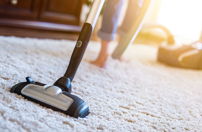 Cleaning carpet with vaccum cleaner