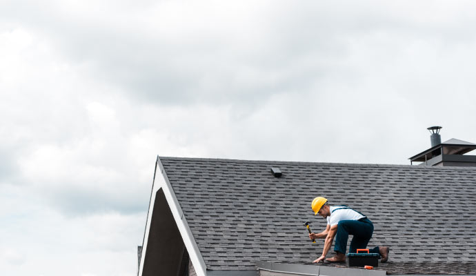 professional repairing roof using equipment